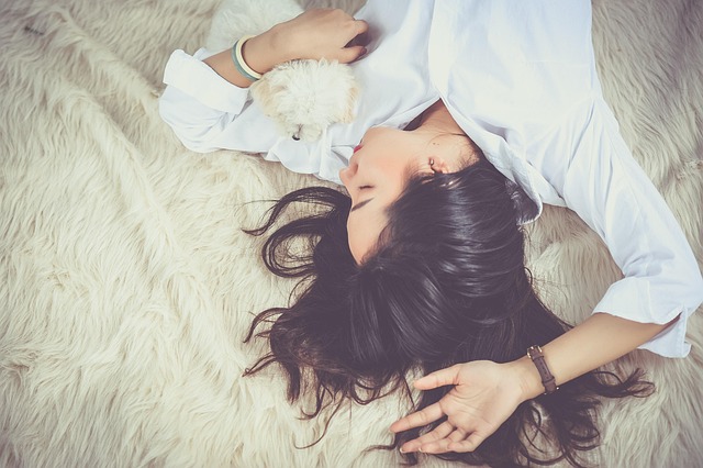 pet owner reading pet care guide with cat and dog at home Canada